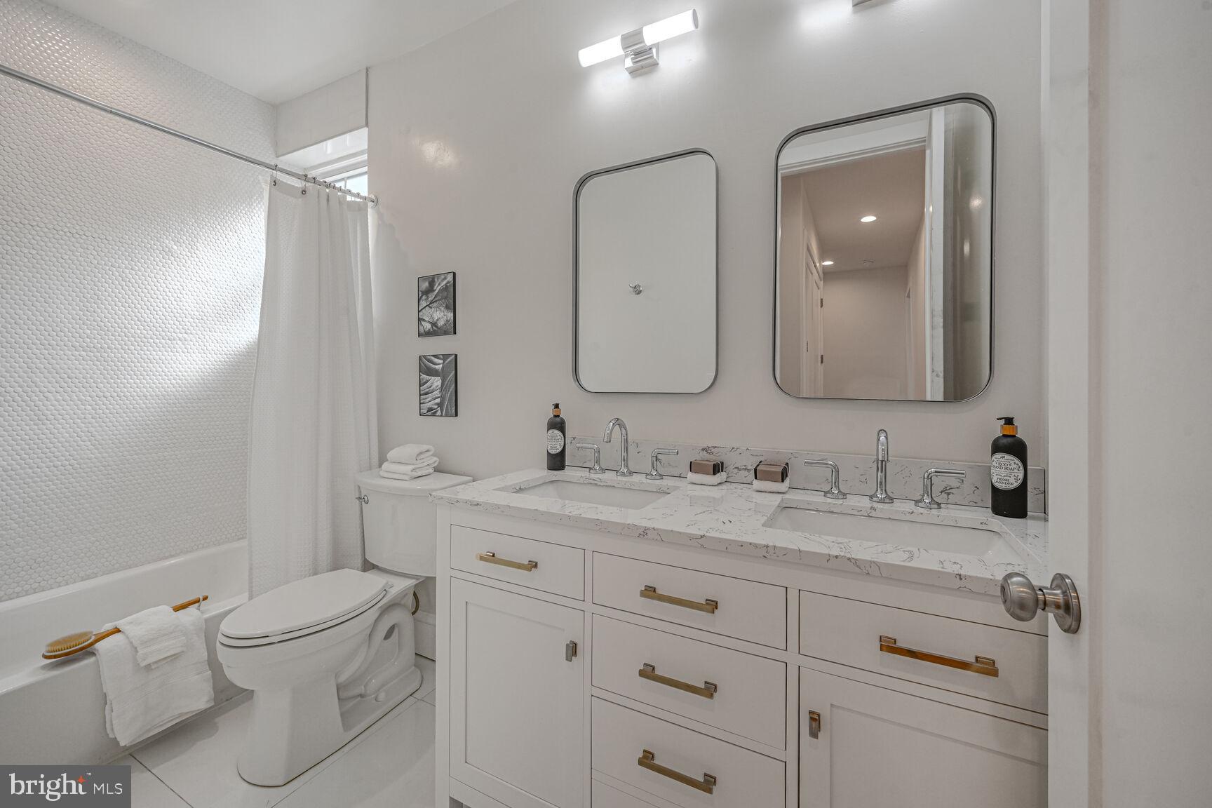 3410 Morrison Street Northwest Washington, DC 20015 - Photo 32 of 71 a bathroom with a toilet a sink a vanity and mirror