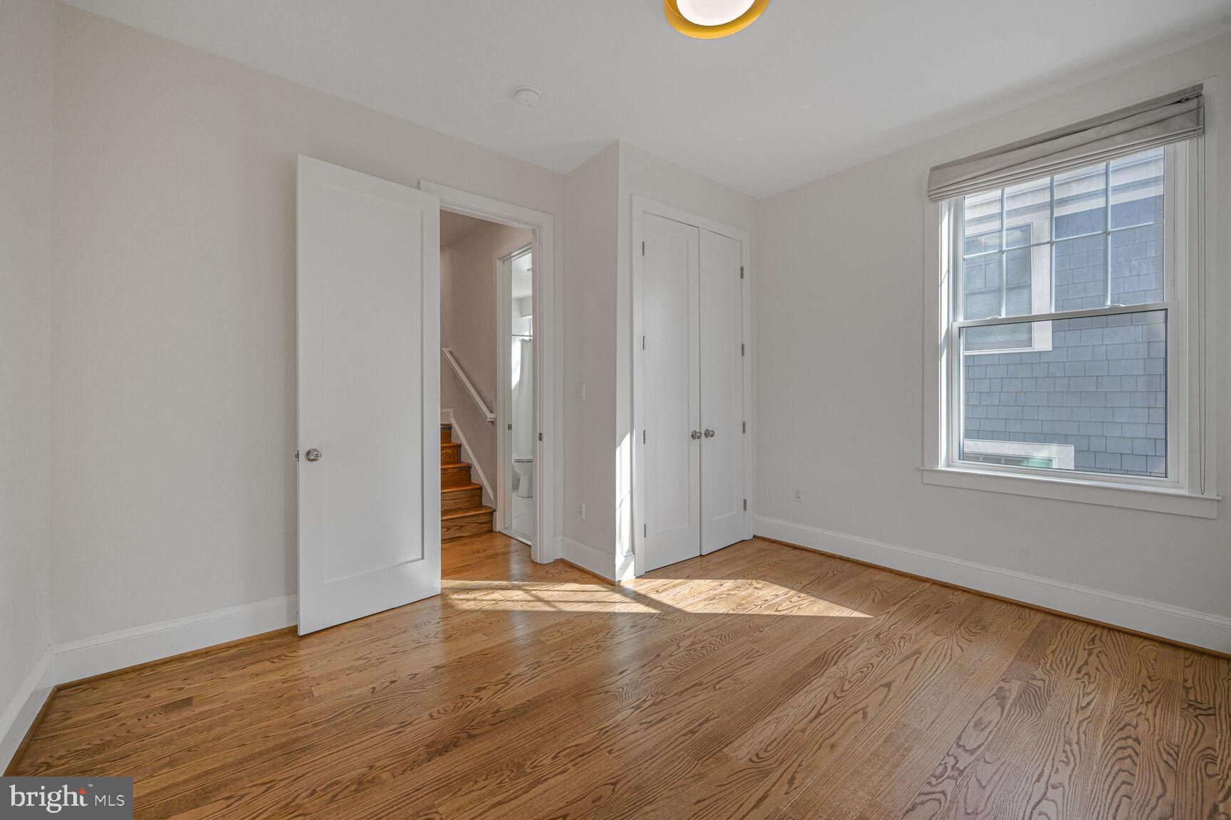 3410 Morrison Street Northwest Washington, DC 20015 - Photo 35 of 71 an empty room with wooden floor and windows
