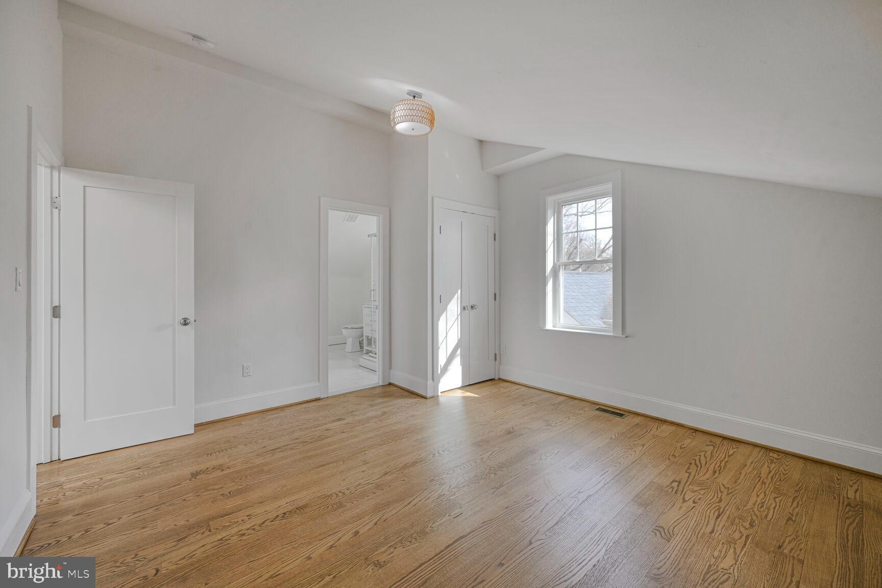 3410 Morrison Street Northwest Washington, DC 20015 - Photo 39 of 71 a view of an empty room with wooden floor and a window