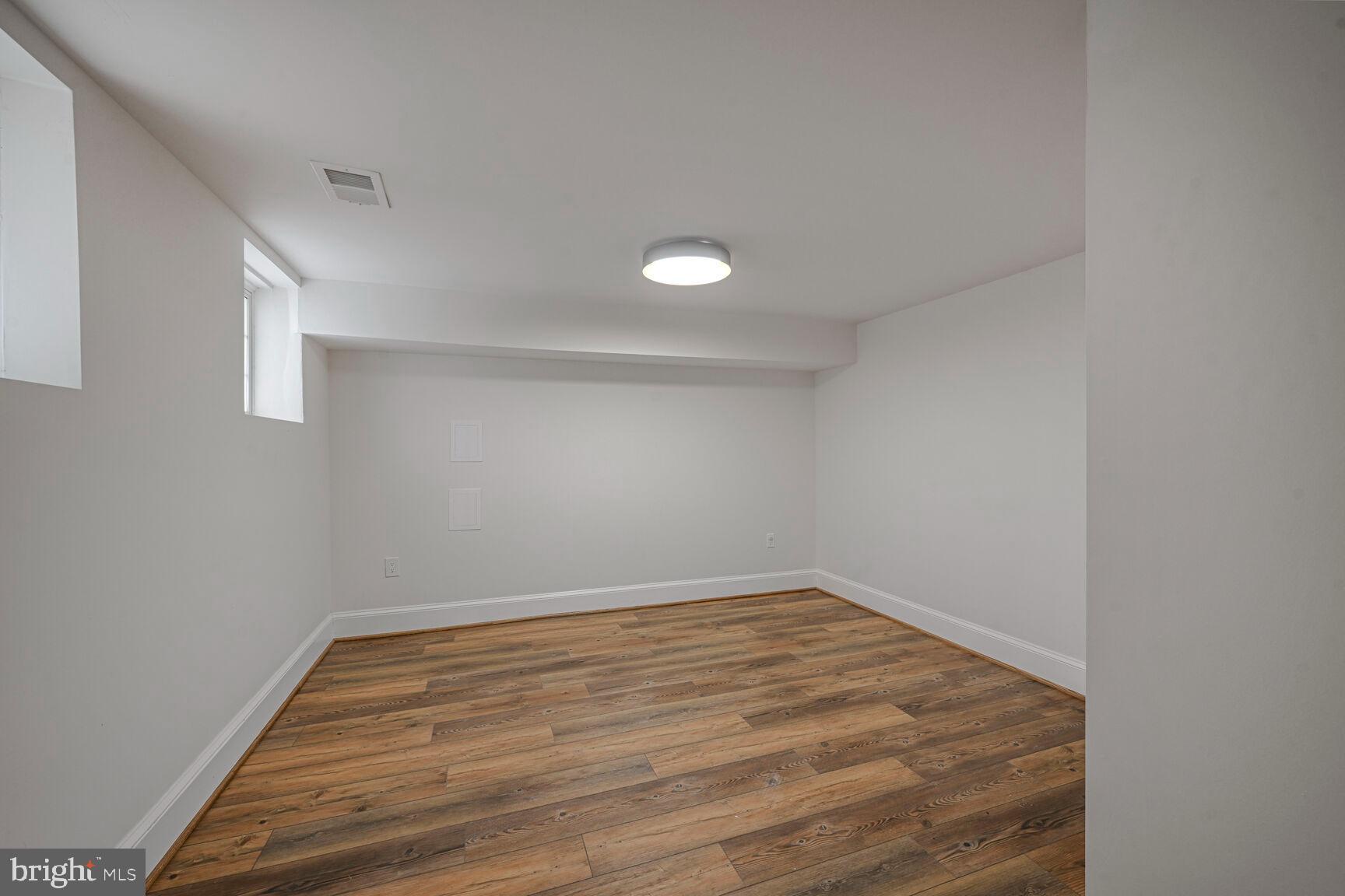 3410 Morrison Street Northwest Washington, DC 20015 - Photo 44 of 71 a view of an empty room with wooden floor and a window