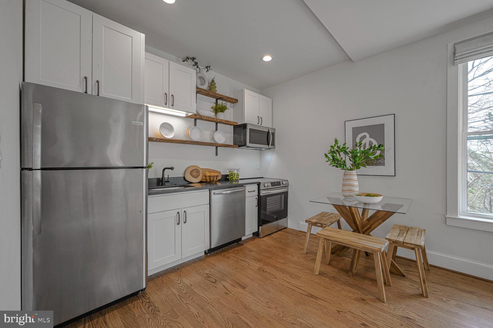 3410 Morrison Street Northwest Washington, DC 20015 - Photo 56 of 71 a kitchen with a refrigerator and a table in it