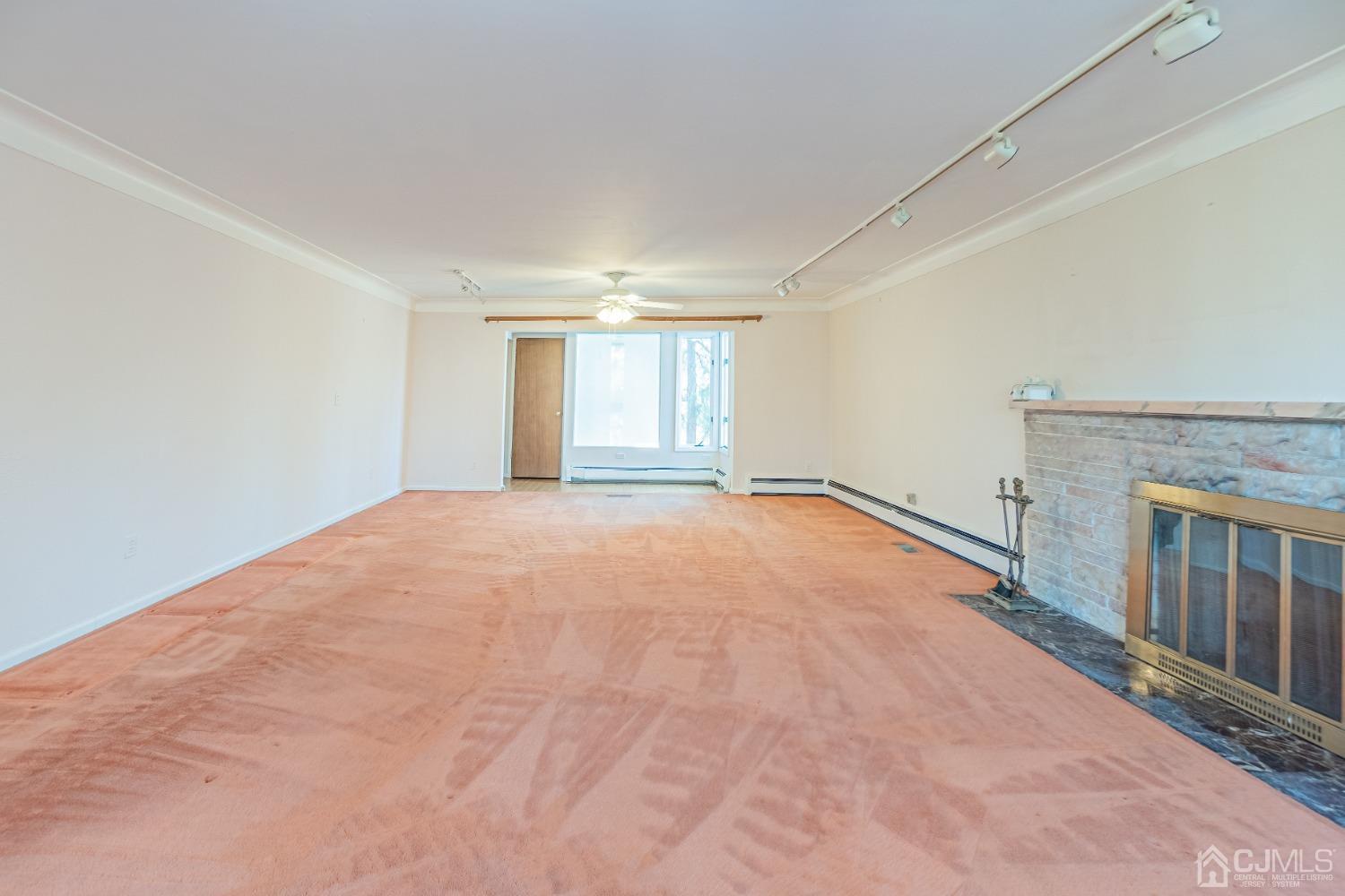 80 Sherwood Road Colonia, NJ 07067 - Photo 12 of 51 a view of an empty room with a fireplace