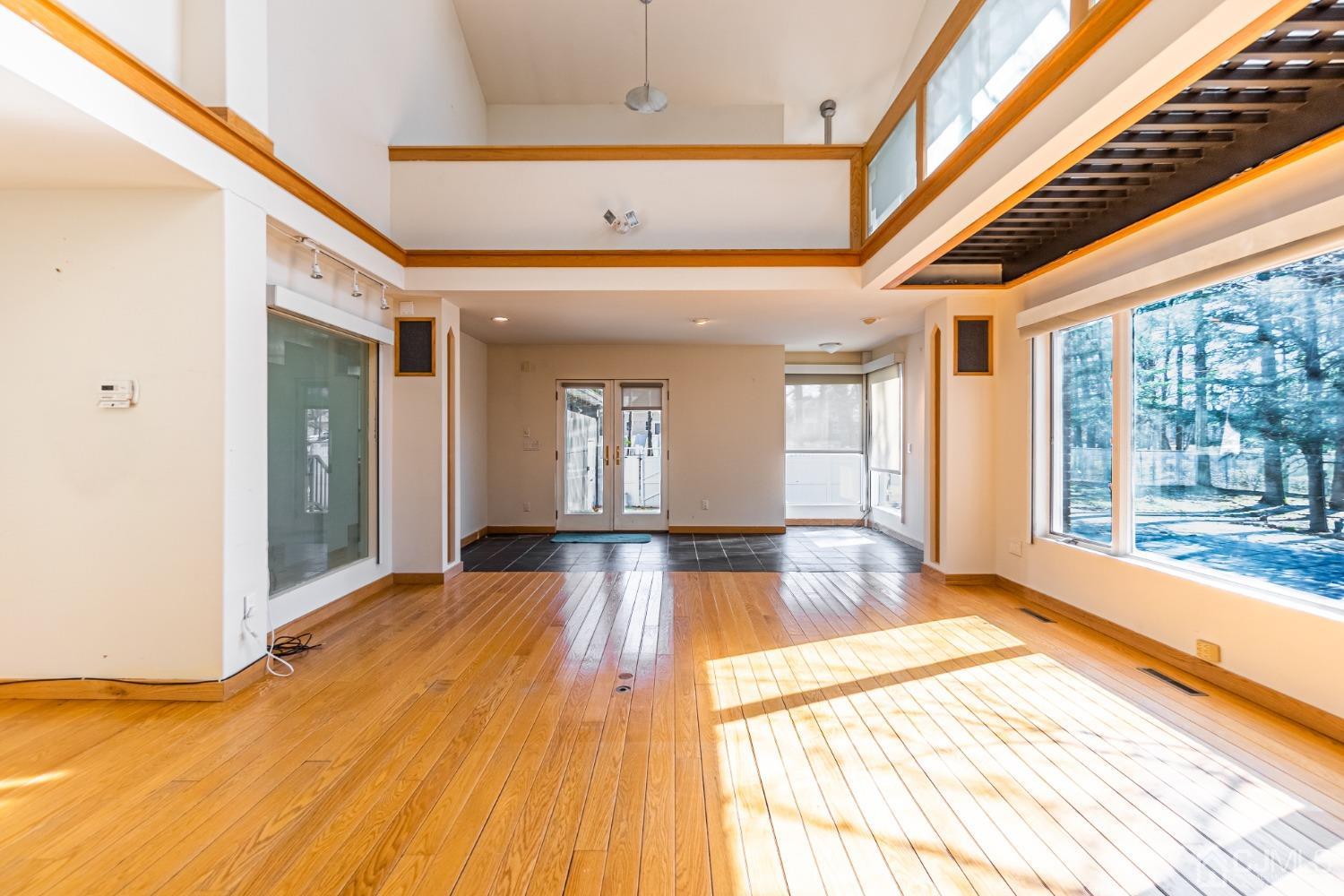 80 Sherwood Road Colonia, NJ 07067 - Photo 16 of 51 a view of an empty room with wooden floor and a fireplace