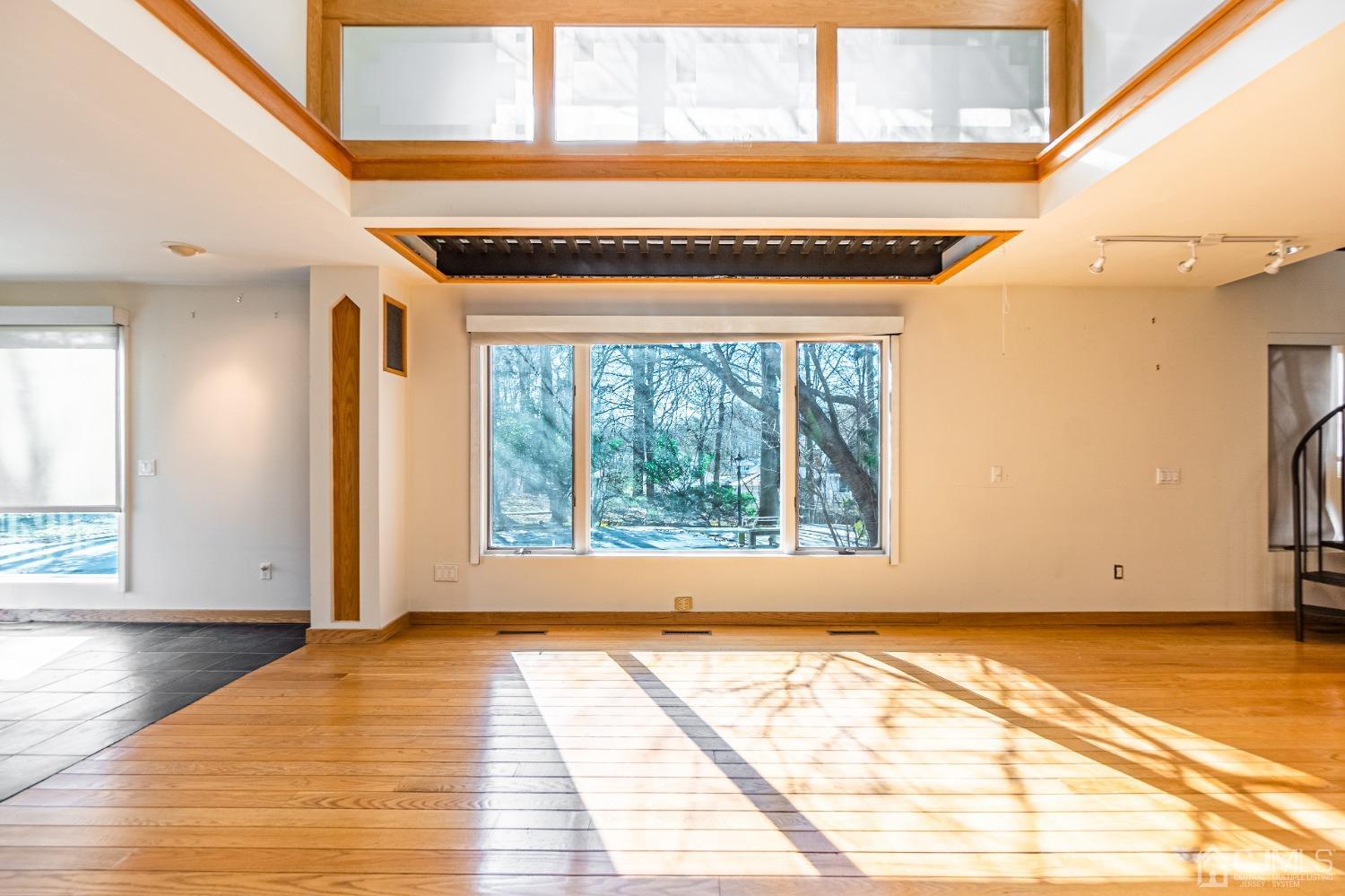 80 Sherwood Road Colonia, NJ 07067 - Photo 17 of 51 a view of an empty room with wooden floor and a window