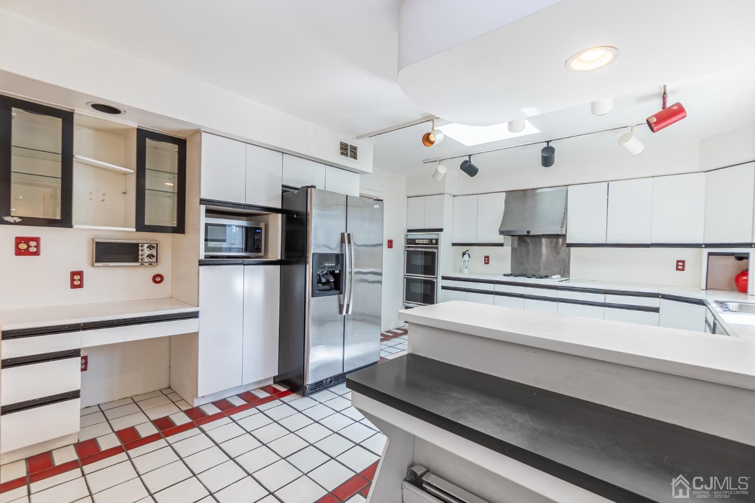 80 Sherwood Road Colonia, NJ 07067 - Photo 23 of 51 a kitchen with stainless steel appliances kitchen island sink refrigerator and stove