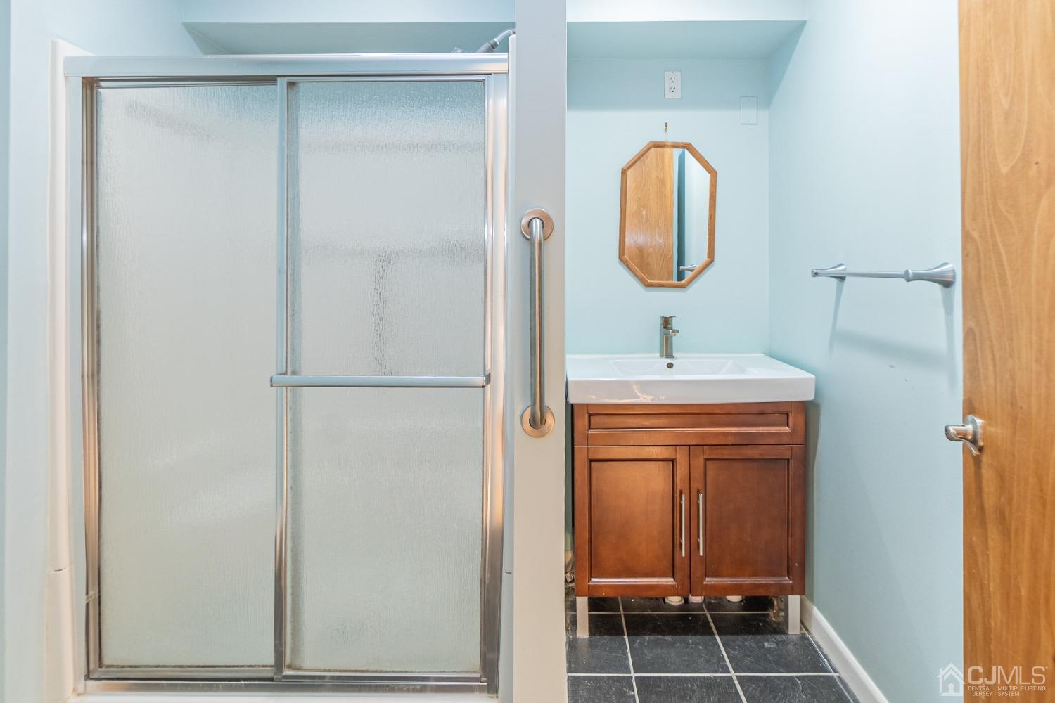 80 Sherwood Road Colonia, NJ 07067 - Photo 26 of 51 a bathroom with a sink and a mirror