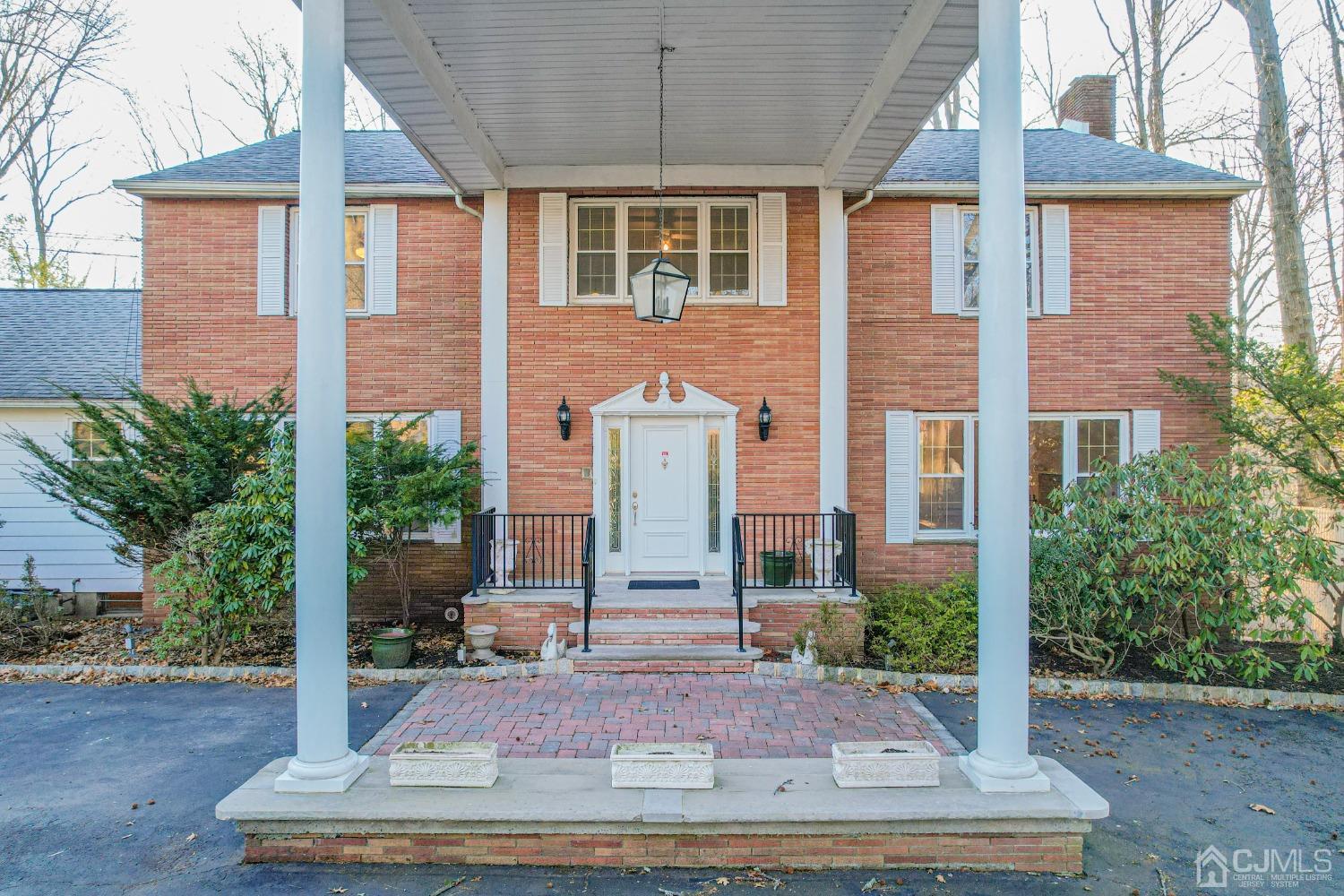 80 Sherwood Road Colonia, NJ 07067 - Photo 3 of 51 a front view of a house with a garden