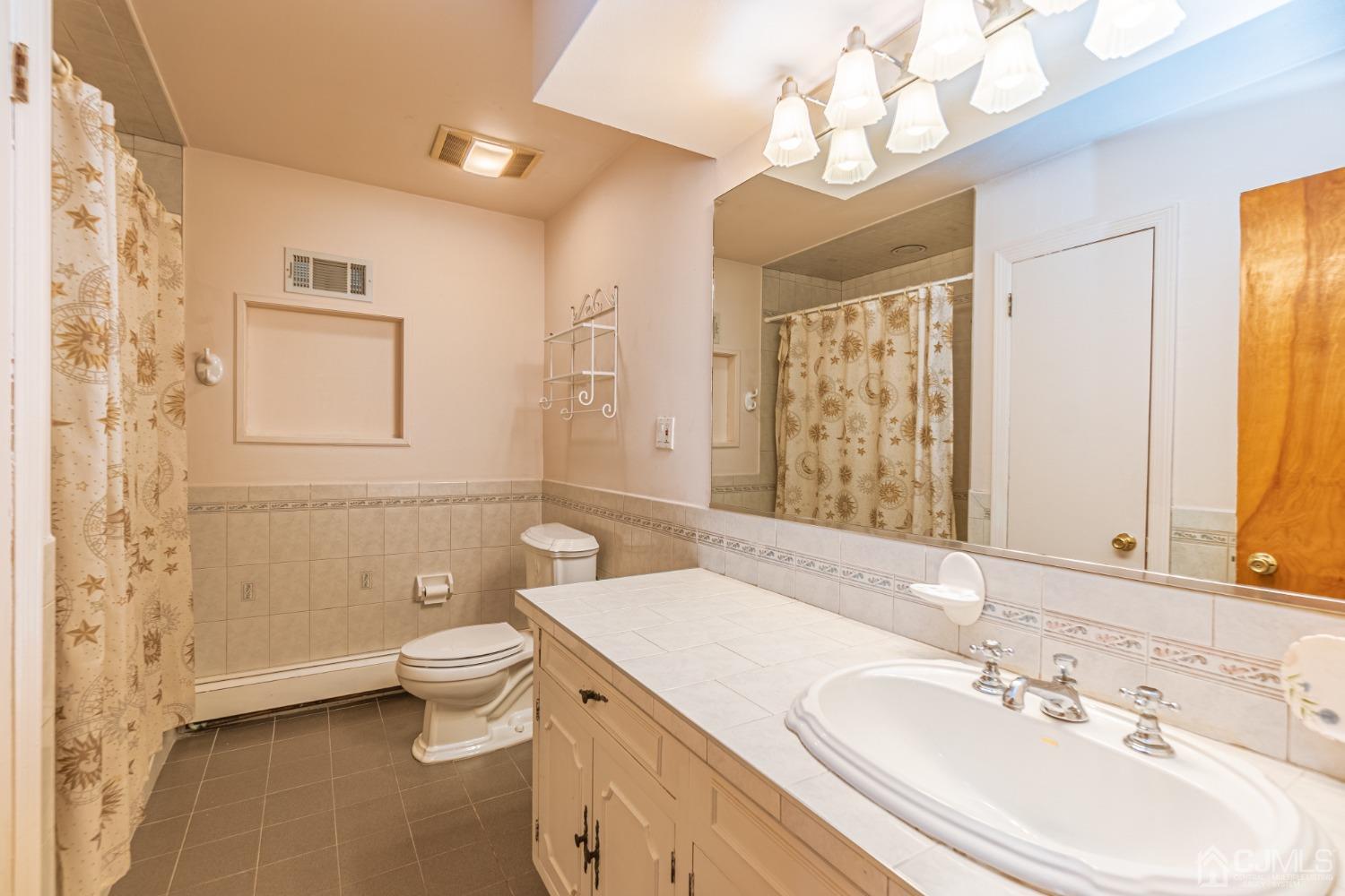 80 Sherwood Road Colonia, NJ 07067 - Photo 36 of 51 a bathroom with a toilet a sink and mirror