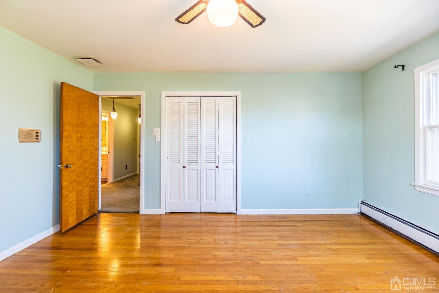 80 Sherwood Road Colonia, NJ 07067 - Photo 38 of 51 a view of an empty room with window and wooden floor