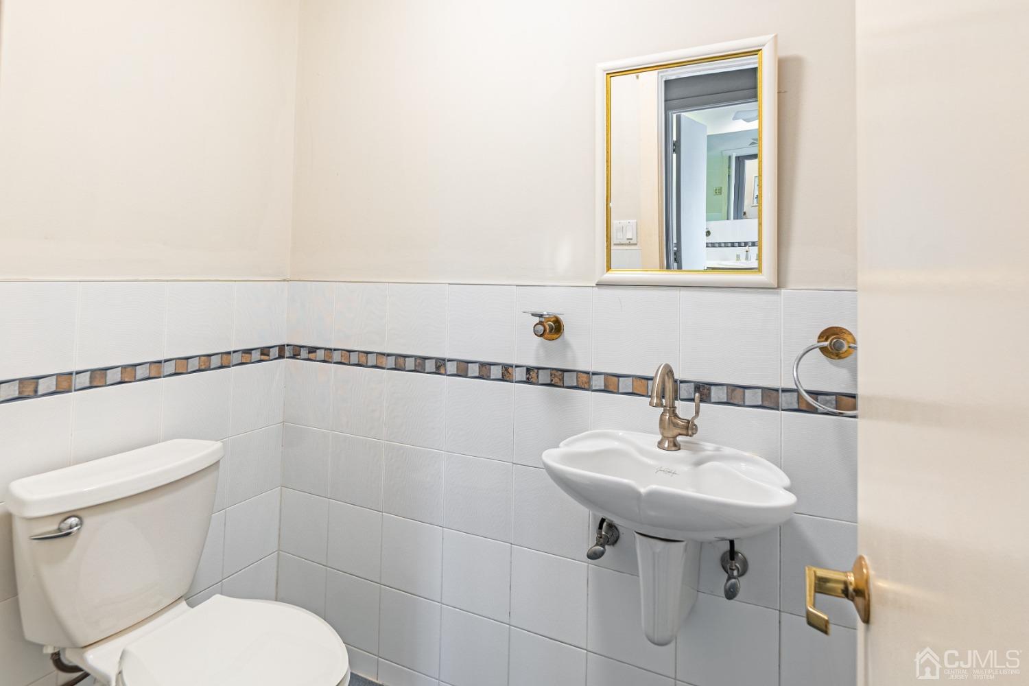 80 Sherwood Road Colonia, NJ 07067 - Photo 39 of 51 a bathroom with a toilet sink and mirror