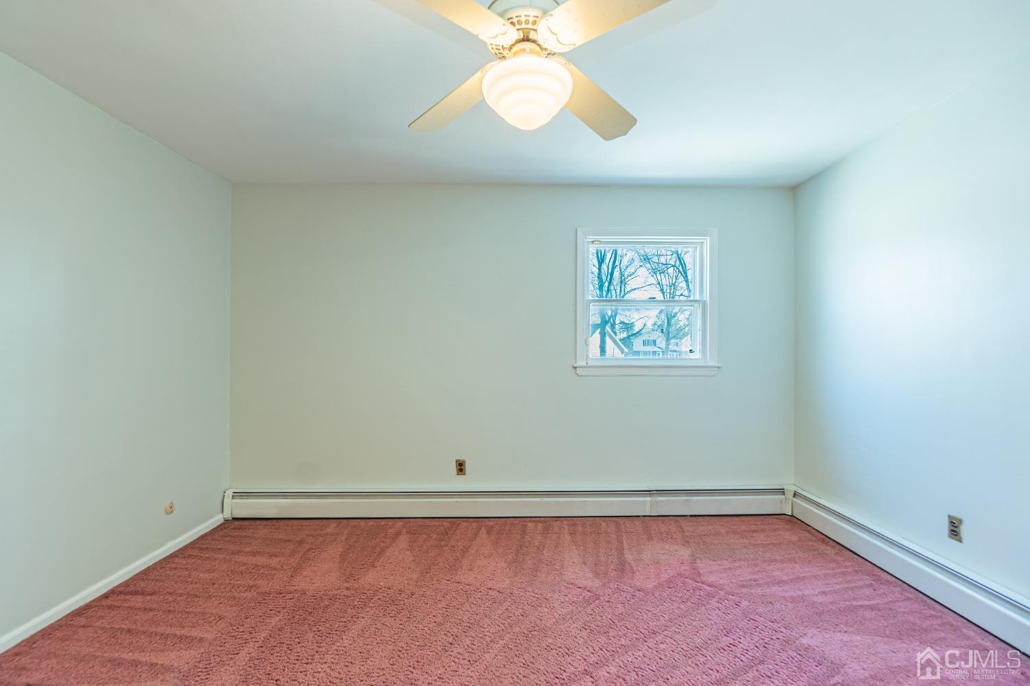 80 Sherwood Road Colonia, NJ 07067 - Photo 40 of 51 an empty room with a window and a fan