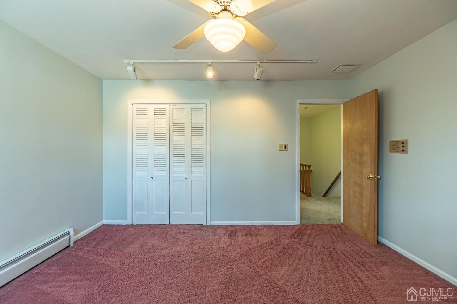 80 Sherwood Road Colonia, NJ 07067 - Photo 41 of 51 an empty room with closet and a chandelier fan
