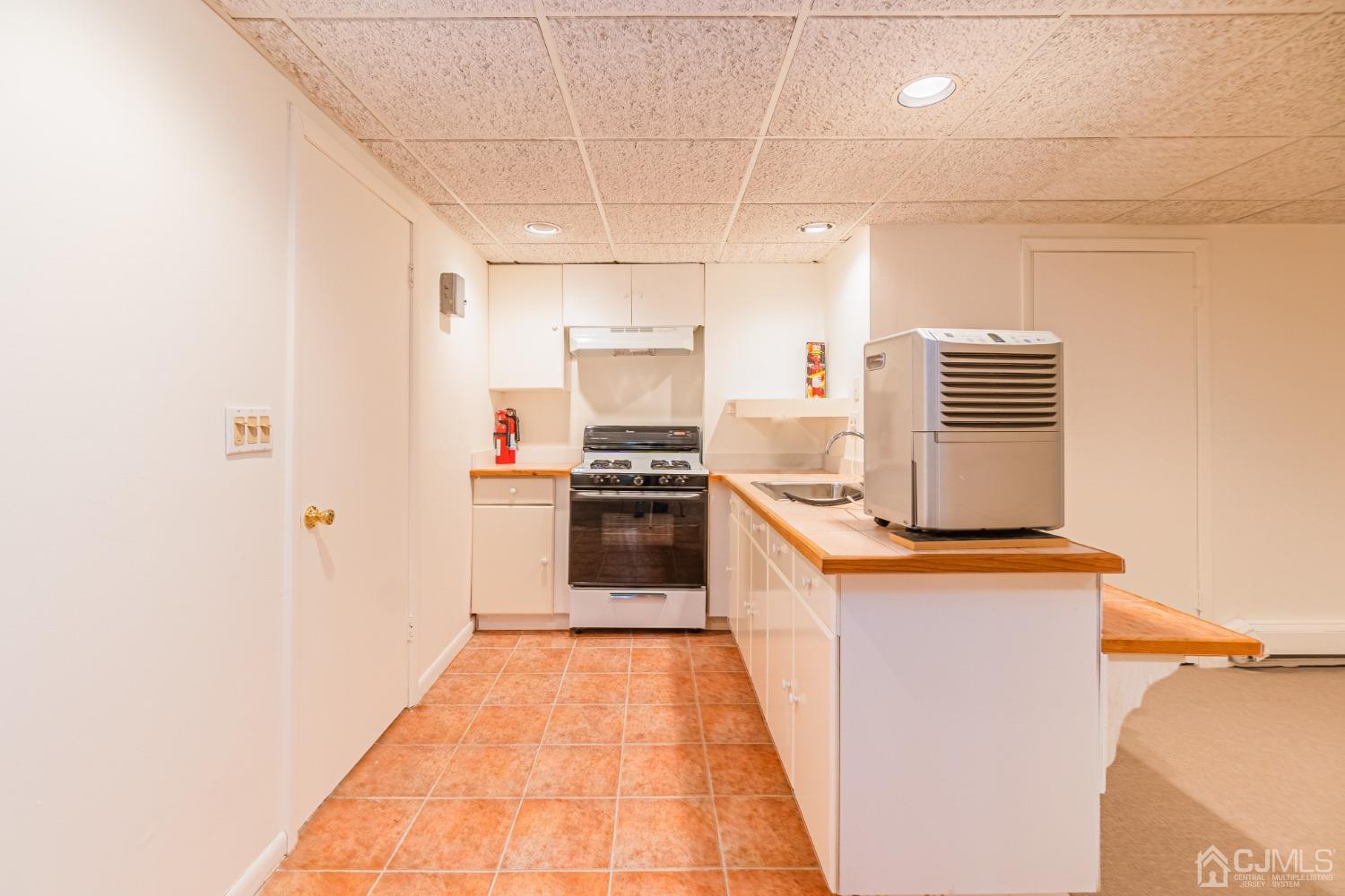 80 Sherwood Road Colonia, NJ 07067 - Photo 49 of 51 a kitchen with stainless steel appliances a stove top oven a sink and a refrigerator