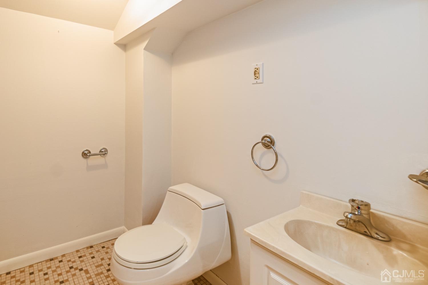 80 Sherwood Road Colonia, NJ 07067 - Photo 51 of 51 a white toilet sitting next to a bathroom sink