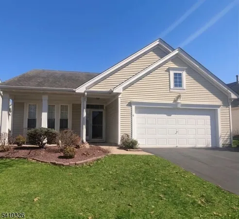 a front view of a house with a yard and outdoor seating