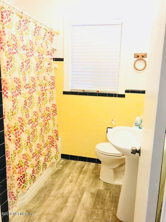 3743 Lilly Road North Jacksonville, FL 32207 - Photo 20 of 43 a bathroom with a toilet and a shower curtain