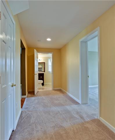 1030 North Sumner Road Portland, TN 37148 - Photo 11 of 20 An extra wide hallway leads to the downstairs bedroom and bath.
