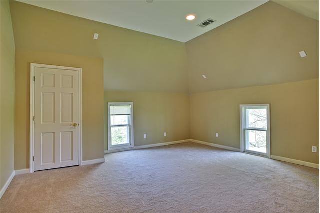 1030 North Sumner Road Portland, TN 37148 - Photo 13 of 20 Upstairs 2nd bedroom with vaulted ceiling, walk in closet, and NEW carpeting.
