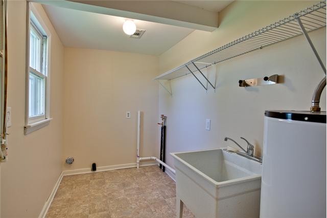 1030 North Sumner Road Portland, TN 37148 - Photo 16 of 20 A large utility room on the main level with a deep sink.