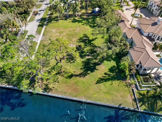 an aerial view of residential houses with yard