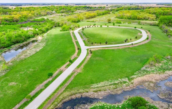 a view of a swimming pool with a garden and trees