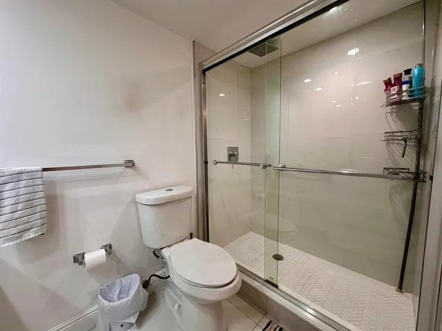 a bathroom with a toilet and a shower