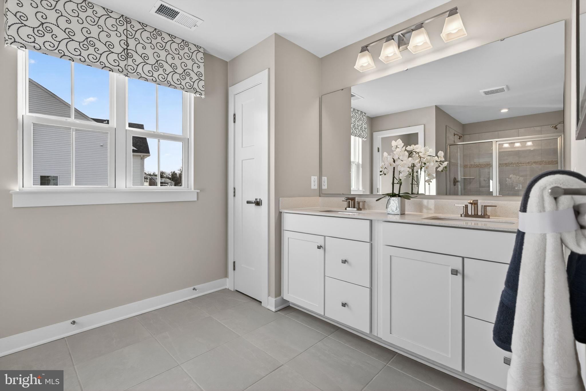 3575 Wildview Lane York, PA 17404 - Photo 35 of 62 a spacious bathroom with a double vanity sink a mirror and a shower