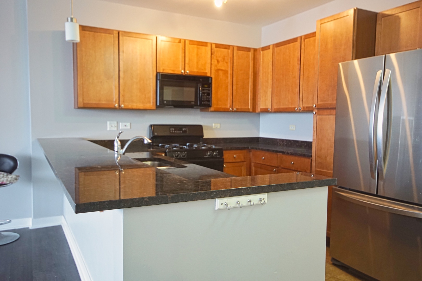 1905 South Wolf Road, Unit 401 Hillside, IL 60162 - Photo 8 of 22 a kitchen with stainless steel appliances granite countertop a refrigerator a sink a stove with white cabinets