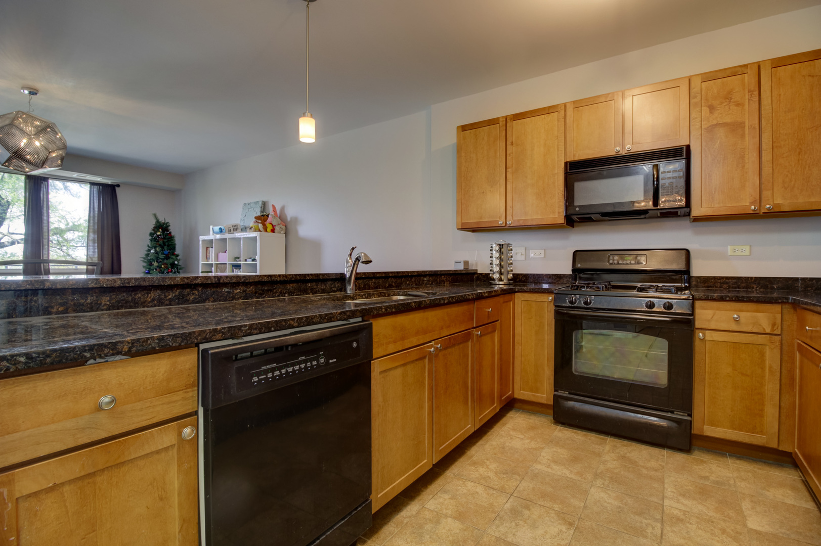 1905 South Wolf Road, Unit 401 Hillside, IL 60162 - Photo 9 of 22 a kitchen with granite countertop a sink a stove top oven and cabinetry