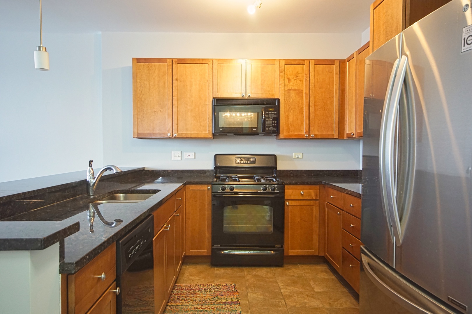 1905 South Wolf Road, Unit 401 Hillside, IL 60162 - Photo 10 of 22 a kitchen with stainless steel appliances granite countertop a sink stove and refrigerator