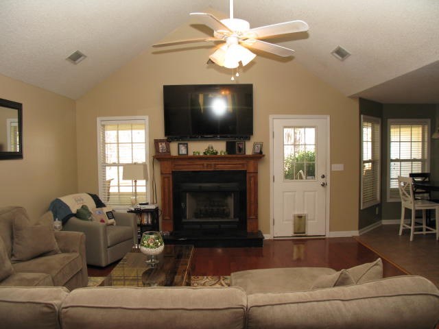 621 Homer Roberts Road Gray, GA 31032 - Photo 12 of 20 a living room with furniture a flat screen tv and a fireplace