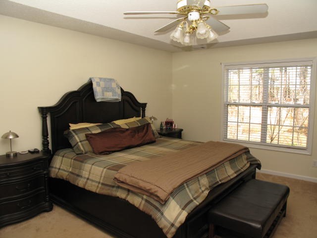 621 Homer Roberts Road Gray, GA 31032 - Photo 14 of 20 a bed sitting in a bedroom next to a window with chandelier