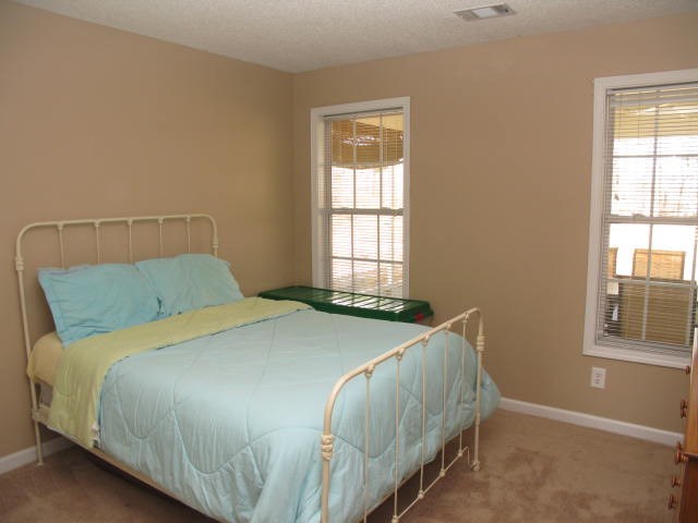621 Homer Roberts Road Gray, GA 31032 - Photo 15 of 20 a bed sitting in a bedroom next to a window