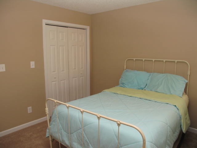 621 Homer Roberts Road Gray, GA 31032 - Photo 16 of 20 a bed sitting in a bedroom next to a window
