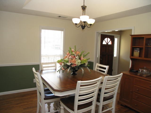621 Homer Roberts Road Gray, GA 31032 - Photo 5 of 20 a dining room with furniture potted plants and wooden floor