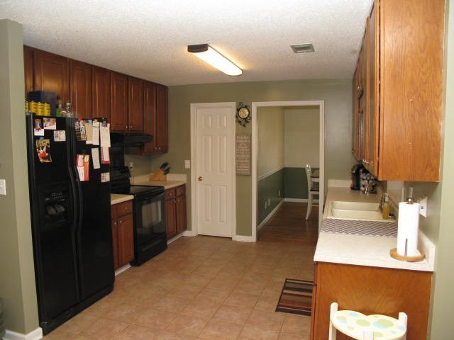 621 Homer Roberts Road Gray, GA 31032 - Photo 7 of 20 a kitchen with stainless steel appliances kitchen island granite countertop a refrigerator a stove and a sink with large window