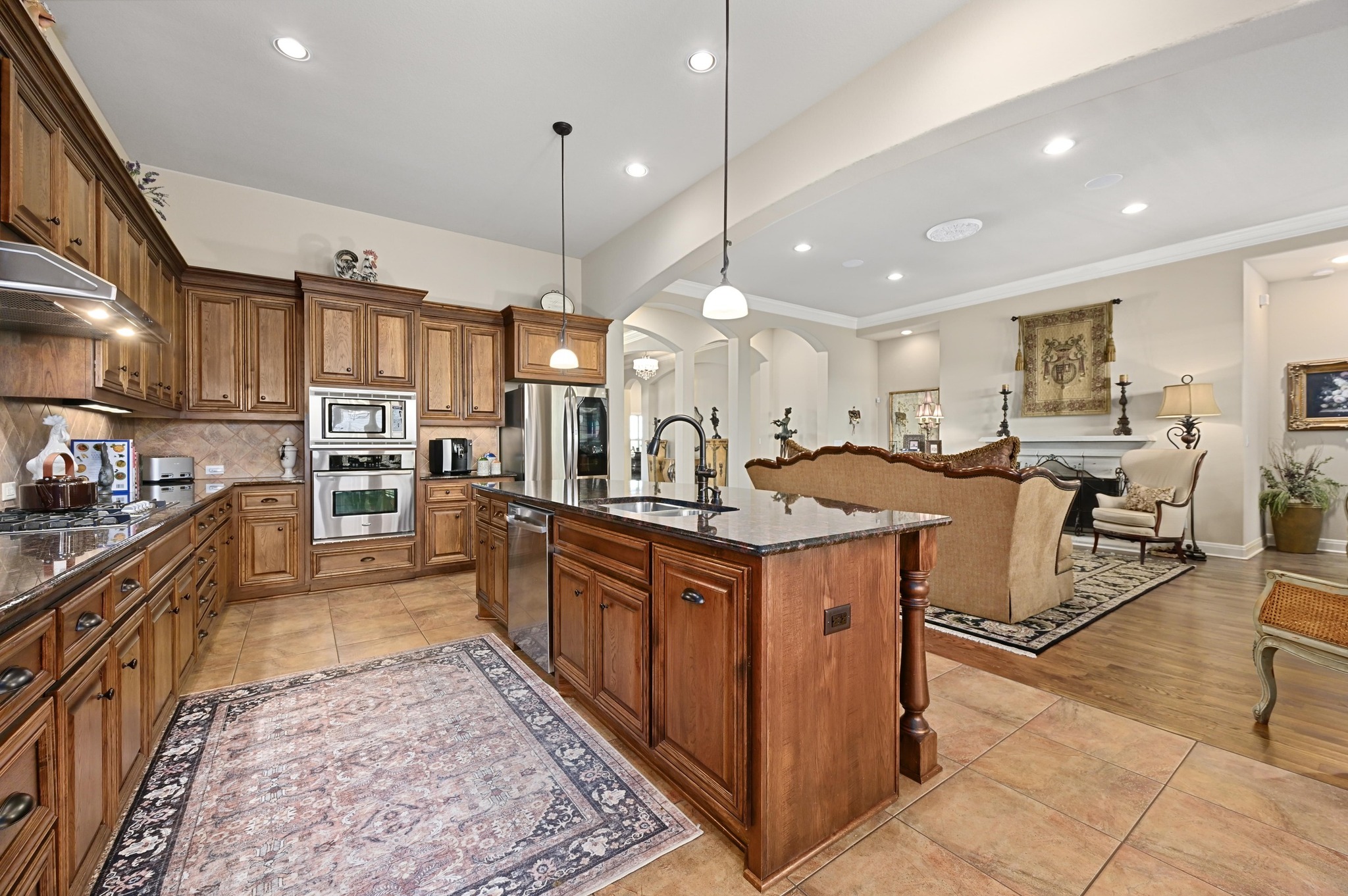 16129 Zagros Way Austin, TX 78738 - Photo 25 of 25 Kitchen with wood finish cabinets, granite counters, and open floor plan