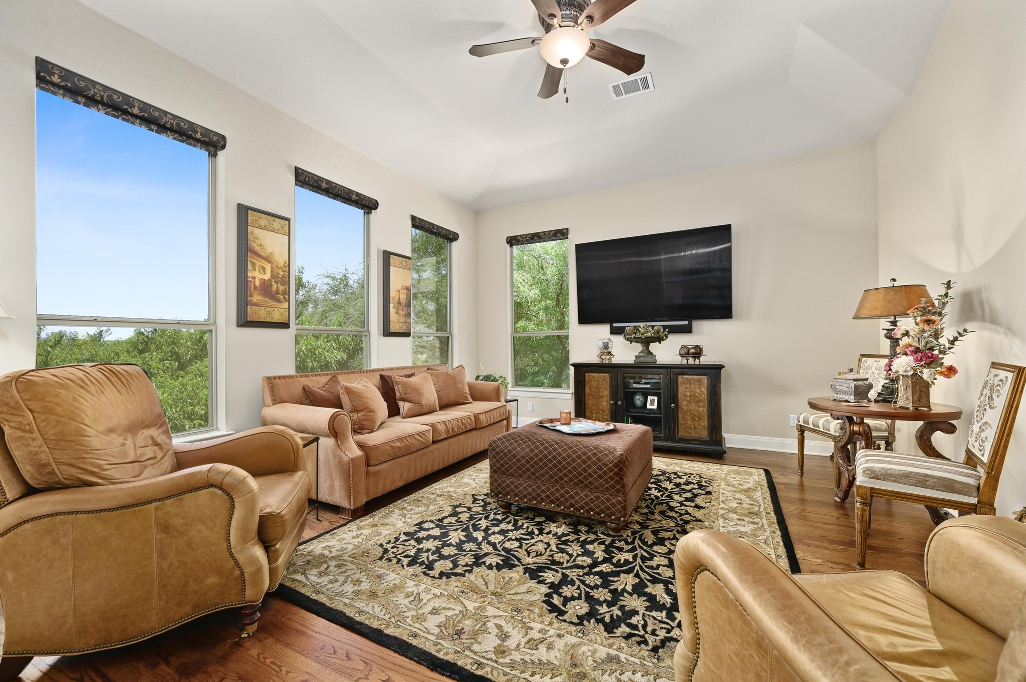 16129 Zagros Way Austin, TX 78738 - Photo 18 of 25 Bonus Room featuring wood floors, raised ceiling and beautiful views across the back