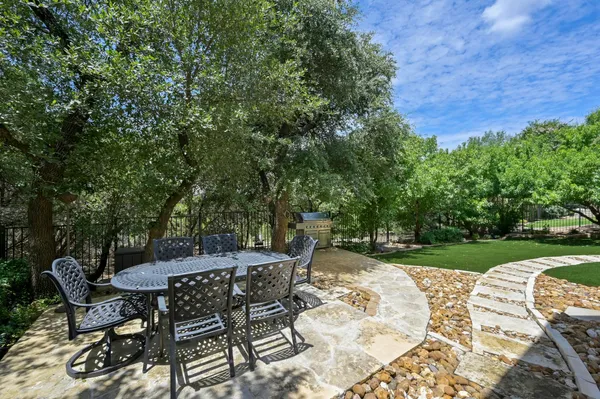 a view of a house with backyard and sitting area
