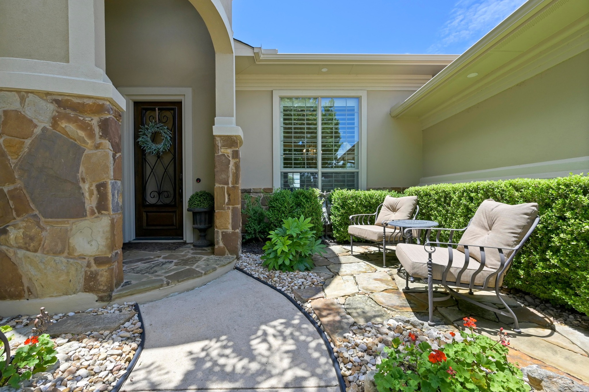 16129 Zagros Way Austin, TX 78738 - Photo 3 of 25 Doorway to property with stone siding stucco siding and a gated courtyard.