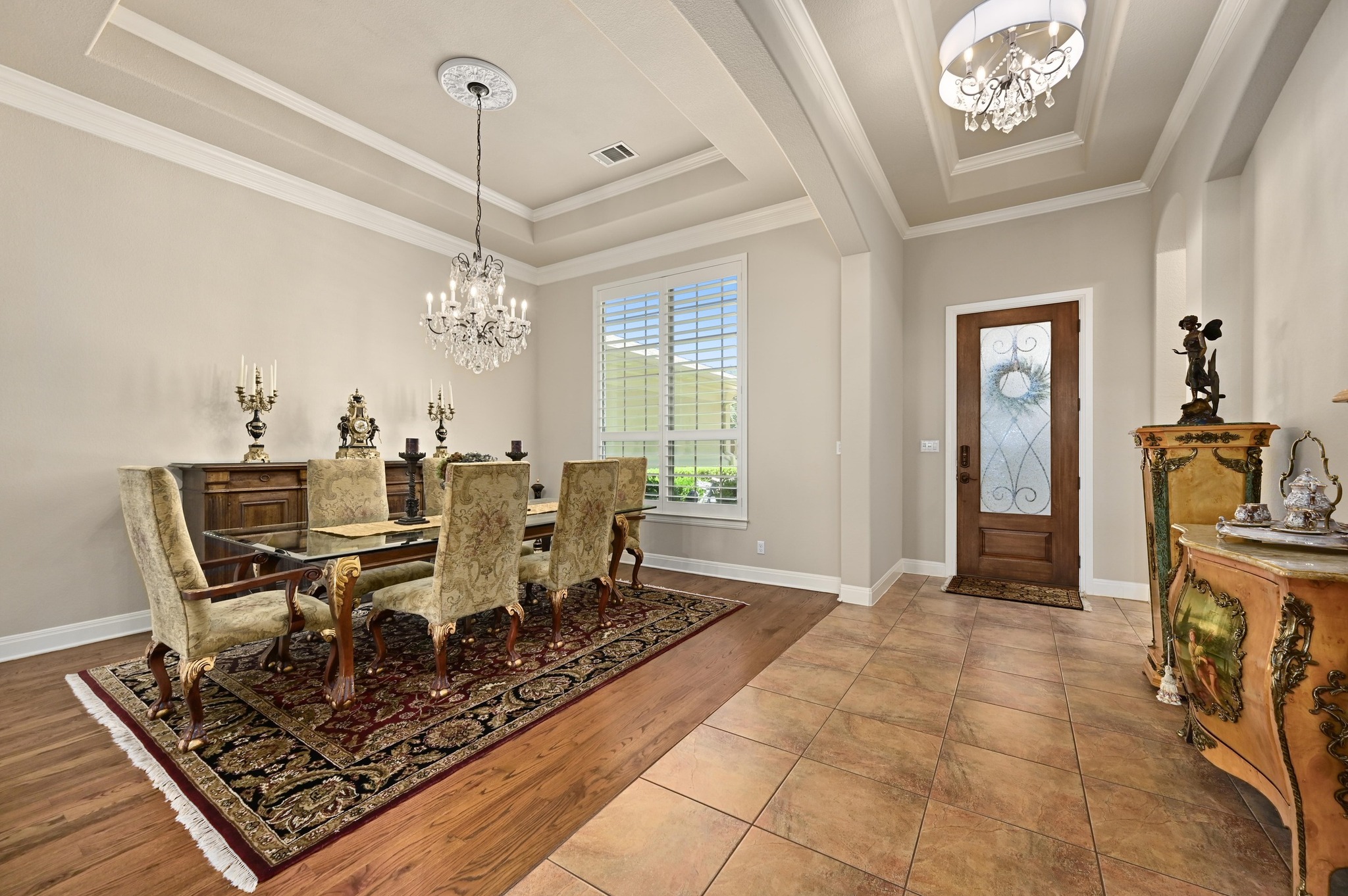 16129 Zagros Way Austin, TX 78738 - Photo 5 of 25 Dining space featuring wood floors, crown molding, high ceiling and plenty of space for dining room furniture.