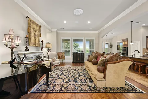 a living room with fireplace furniture and a large window