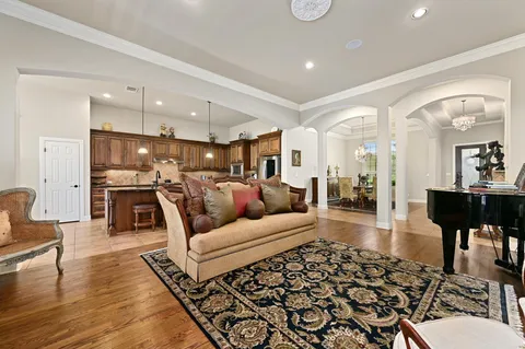a living room with lots of furniture and kitchen view