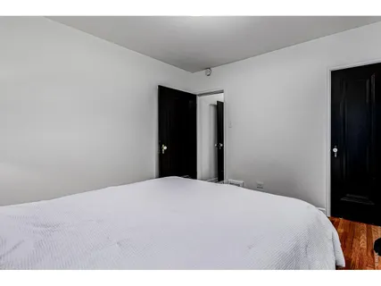 a bedroom with a bed and a table