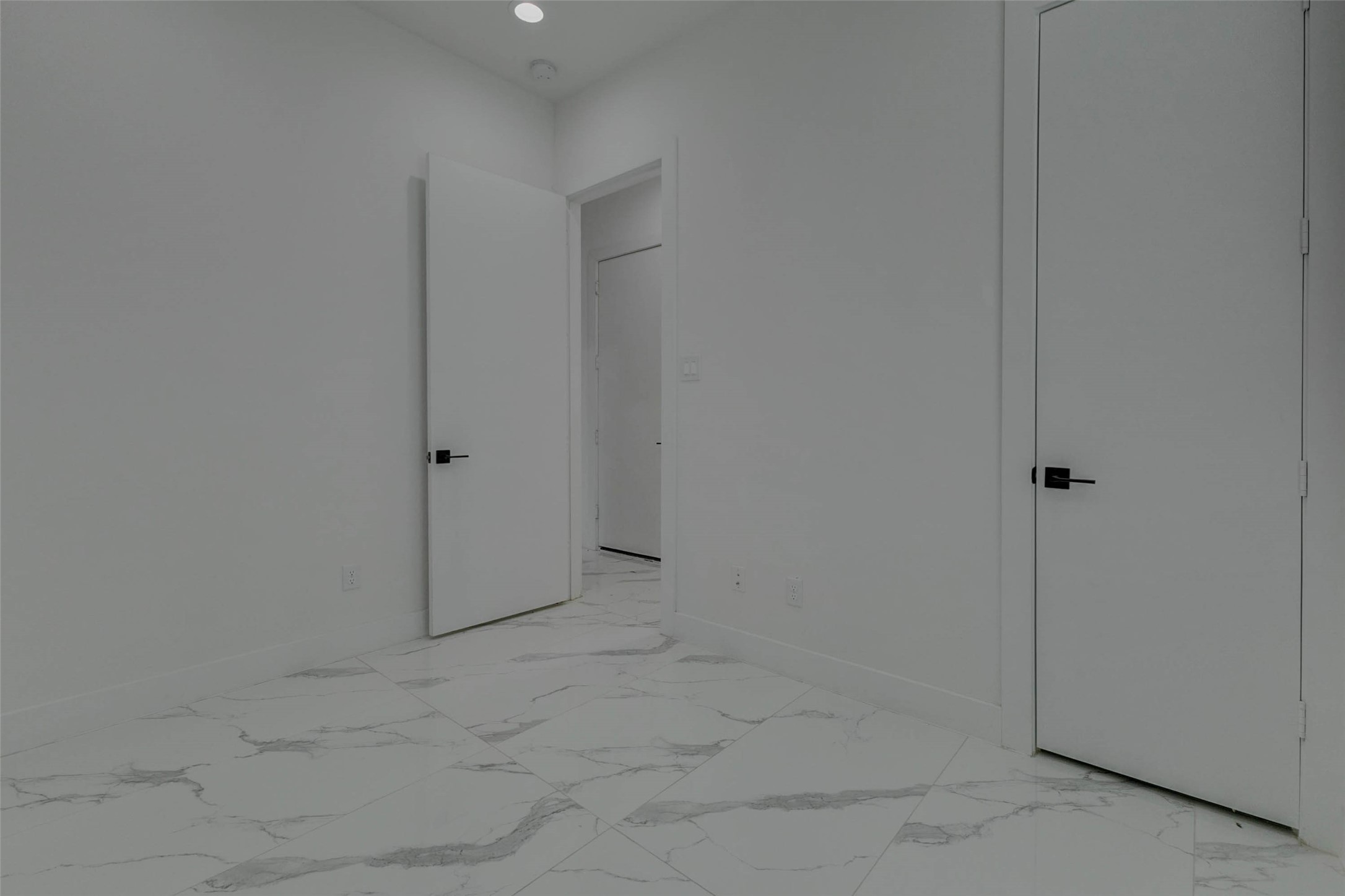 5705 Elysium Street Houston, TX 77091 - Photo 6 of 22 The bathroom features a sleek vanity, modern mirror, clean cabinetry, and a light, spa-like color palette. Black fixtures add contrast and a contemporary designer touch.