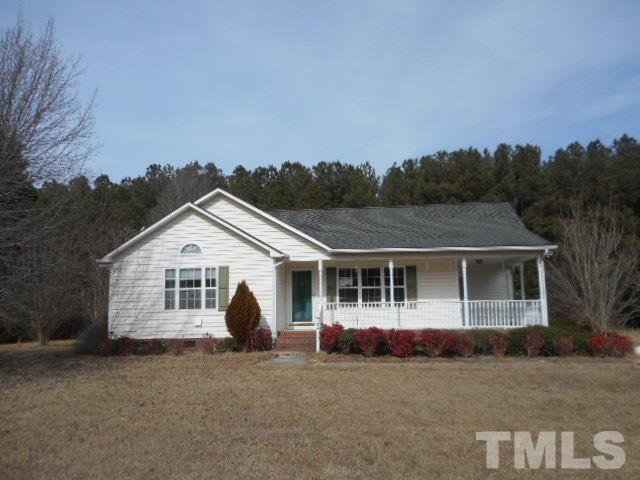 124 Forest Ridge Drive Willow Spring, NC 27592 - Photo 1 of 12 front view of a house with a garden