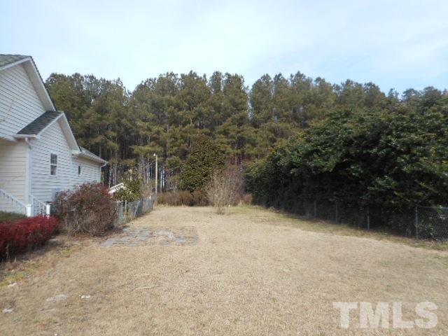 124 Forest Ridge Drive Willow Spring, NC 27592 - Photo 12 of 12 a backyard of a house with large trees