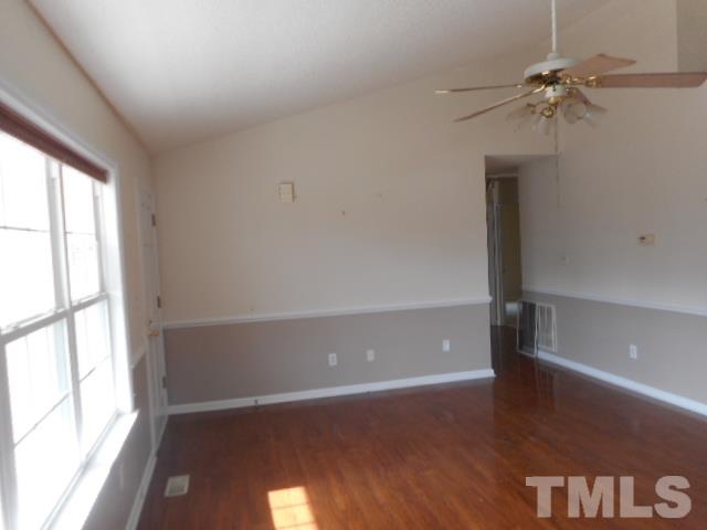 124 Forest Ridge Drive Willow Spring, NC 27592 - Photo 3 of 12 a view of an empty room with a window and wooden floor
