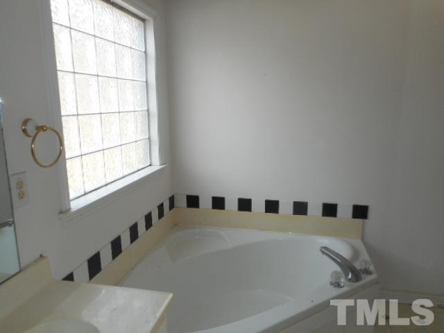124 Forest Ridge Drive Willow Spring, NC 27592 - Photo 5 of 12 a bathroom with windows and tub
