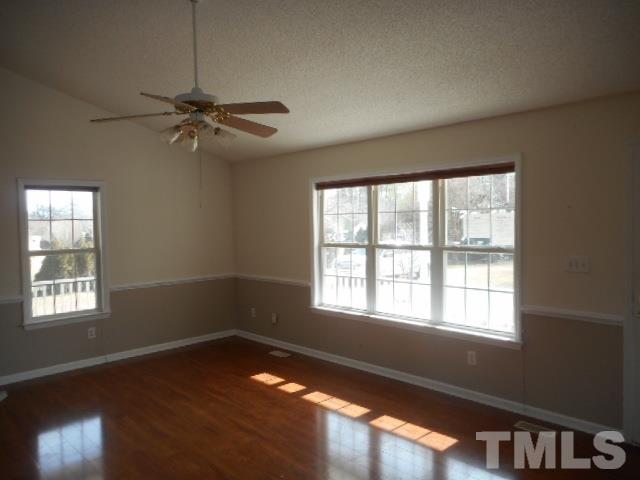 124 Forest Ridge Drive Willow Spring, NC 27592 - Photo 6 of 12 a view of an empty room with wooden floor and a window